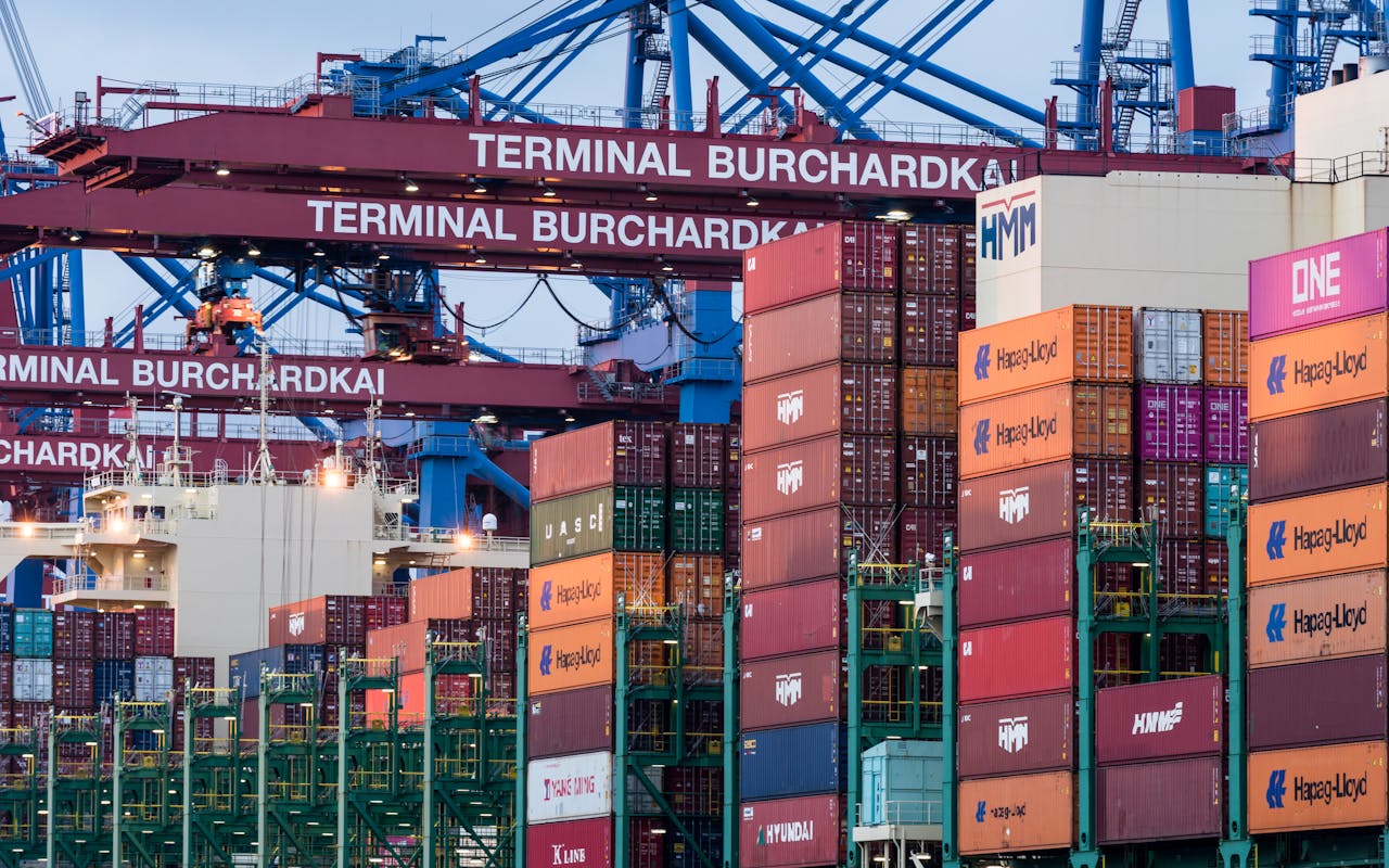 services-01 View of shipping containers and cranes at Hamburg's Burchardkai terminal.